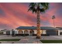 Beautiful single-story home with arched entryway, desert landscaping, and an oversized palm tree at 1949 E Oxford Dr, Tempe, AZ 85283