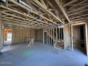 Unfinished basement under construction with staircase, exposed framing, and unfinished ceilings at 1970 W Lariat Ln, Phoenix, AZ 85085