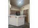Eat-in kitchen featuring stainless steel refrigerator and bar seating at 20625 N 104Th Ave, Peoria, AZ 85382