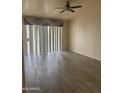 Bright living room with wood-look tile flooring and sliding glass doors at 20625 N 104Th Ave, Peoria, AZ 85382