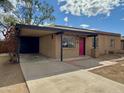 Single story home with brick exterior, attached carport, and desert landscaping at 2307 W Sierra St, Phoenix, AZ 85029