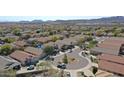 Expansive aerial view of a desert community showcases neighborhood layout and landscaping at 2411 W Oberlin Way, Phoenix, AZ 85085