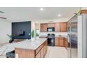 Stylish kitchen showcasing granite counters, stainless steel appliances, and a kitchen island with bar stool seating at 3010 N Majestic Ct, Casa Grande, AZ 85122