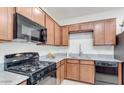 Well-equipped kitchen featuring granite countertops, gas range, microwave, and plenty of cabinet space at 3010 N Majestic Ct, Casa Grande, AZ 85122