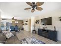 Open-concept living area with neutral tones, a brick fireplace, and seamless transition to the dining space at 3243 E Forge Ave, Mesa, AZ 85204