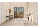 Welcoming home foyer with double glass doors and decorative tile flooring at 37015 N 27Th Pl, Cave Creek, AZ 85331