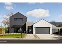 Contemporary home features a unique facade with a mix of dark siding, stone accents, and a well-manicured lawn at 4318 E Cheery Lynn Rd, Phoenix, AZ 85018