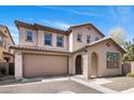 Two-story home featuring a tan exterior, attached garage, and desert landscaping at 4710 E Tierra Buena Ln, Phoenix, AZ 85032