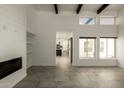 Spacious living room with modern fireplace, high ceilings, and large windows at 4836 N 72Nd Way, Scottsdale, AZ 85251