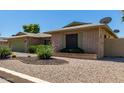 Charming single-story brick home featuring desert landscaping and a spacious two-car garage at 4855 W Turquoise Ave, Glendale, AZ 85302