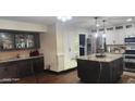 Spacious kitchen featuring stainless steel appliances, granite countertops, and dark wood cabinets at 4855 W Turquoise Ave, Glendale, AZ 85302