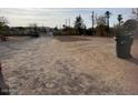 A vacant lot with a gravel driveway and trash can, awaiting new construction or landscaping project at 502 E Roeser Rd, Phoenix, AZ 85040