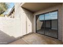 View of outdoor patio with exterior door and sliding glass door access to interior at 533 W Guadalupe Rd # 1068, Mesa, AZ 85210