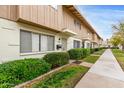 Pleasant view of townhome exteriors, featuring meticulous landscaping and sidewalks at 5339 N Black Canyon Hwy, Phoenix, AZ 85015