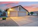 This home features a spacious three-car garage with ample driveway space at 5830 W Cinnabar Ave, Glendale, AZ 85302
