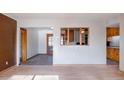 View of the living room with tile floors, multiple doorways, and brick wall at 6320 N 30Th Dr, Phoenix, AZ 85017