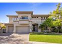 Striking two-story stucco home featuring manicured lawn and three-car garage at 6522 N 27Th St, Phoenix, AZ 85016