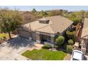Lovely home featuring a three-car garage, well manicured lawn, mature trees, and a tile roof at 7214 N 88Th Ln, Glendale, AZ 85305