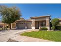 Charming single story home featuring a three-car garage, low maintenance landscaping, and a tile roof at 7214 N 88Th Ln, Glendale, AZ 85305