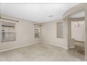 Open-concept living area features carpeted floors, multiple windows, and an arched entryway, creating a welcoming space at 863 E Waterview Pl, Chandler, AZ 85249