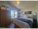 Bright main bedroom with large window, hardwood floors, and ample closet space at 8700 E University Dr # 649, Mesa, AZ 85207