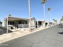 Quiet neighborhood street featuring well-maintained homes with covered parking at 1027 S Prospector Dr, Apache Junction, AZ 85119