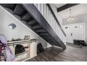 Inviting entryway featuring a staircase, a modern sliding-door console and a double door entry at 1027 W Natal Ave, Mesa, AZ 85210