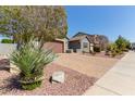 Charming home exterior with mature landscaping, a paver driveway and a two-car garage at 10822 E Ramblewood Cir, Mesa, AZ 85212