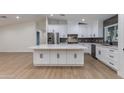Modern kitchen with sleek white cabinetry, stainless steel appliances, and stone countertops at 12444 N 33Rd St, Phoenix, AZ 85032