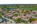 Beautiful aerial view showcasing a residential neighborhood with tile roofs, lush landscaping, and a golf course nearby at 13587 W Cypress St, Goodyear, AZ 85395