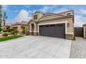 Beautiful home featuring a spacious driveway leading to a two-car garage at 17263 N Bala Dr, Maricopa, AZ 85138