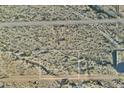 An aerial view of a vacant lot in a developing area with a marked off square by surveyors at 20179 W Highland Ave, Litchfield Park, AZ 85340