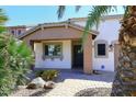 Inviting front entrance with desert landscaping and a cozy covered porch at 21047 N Alma Dr, Maricopa, AZ 85138