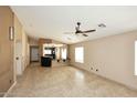 Spacious living room featuring neutral walls, tile flooring, and natural light at 21047 N Alma Dr, Maricopa, AZ 85138