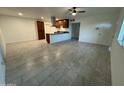 Open-concept living area with tiled floors and stainless steel hood in kitchen area at 2301 W Montebello Ave, Phoenix, AZ 85015