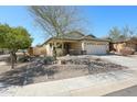 Charming single-story home with a two car garage, xeriscape landscaping, and neutral color palette at 28604 N 21St Ln, Phoenix, AZ 85085