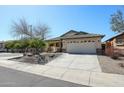 Charming single-story home with a two car garage, xeriscape landscaping, and neutral color palette at 28604 N 21St Ln, Phoenix, AZ 85085
