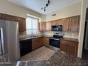 Well-lit kitchen featuring stainless steel appliances, granite countertops, and light-colored cabinets at 3232 E Kerry Ln, Phoenix, AZ 85050