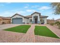 Charming single-story home with well-manicured front yard and appealing walkway leading to the entrance at 35282 N Shorthorn Trl, San Tan Valley, AZ 85143