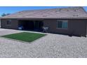 Backyard features gravel landscaping, an artificial grass area, and a covered patio at 3829 N Princeton Ln, Casa Grande, AZ 85122