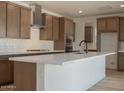 Open kitchen with large island, stainless steel appliances, and modern cabinetry at 40147 N Alameda Dr, San Tan Valley, AZ 85140