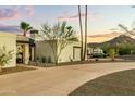 Elegant home exterior with lush desert landscaping and mountain views in the background at 4625 E Mountain View Rd, Phoenix, AZ 85028