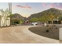 Scenic view of desert property featuring driveway, home, and mountain backdrop at 4625 E Mountain View Rd, Phoenix, AZ 85028