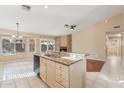 Kitchen with a kitchen island, granite countertops, stainless steel appliances, and a view of the breakfast nook at 4693 W Tara Dr, Chandler, AZ 85226