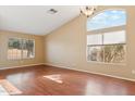 Bright living room with vaulted ceilings, multiple windows, and sleek wood floors, providing ample natural light at 4693 W Tara Dr, Chandler, AZ 85226