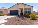 Well-kept home boasting a two-car garage, desert landscaping, and a welcoming entrance at 5101 E Sharbel Rd, San Tan Valley, AZ 85143