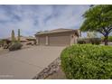 Beautiful single story home with a desert landscape and driveway at 9142 E La Posada Ct, Scottsdale, AZ 85255