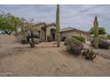 Landscaped front yard with desert foliage and a well-maintained lawn at 9142 E La Posada Ct, Scottsdale, AZ 85255