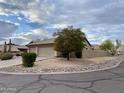 Suburban home featuring desert landscaping, a two-car garage and a circular driveway at 9142 E La Posada Ct, Scottsdale, AZ 85255