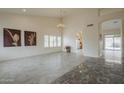 Spacious living room with tile floors, large windows, and a chandelier at 9142 E La Posada Ct, Scottsdale, AZ 85255